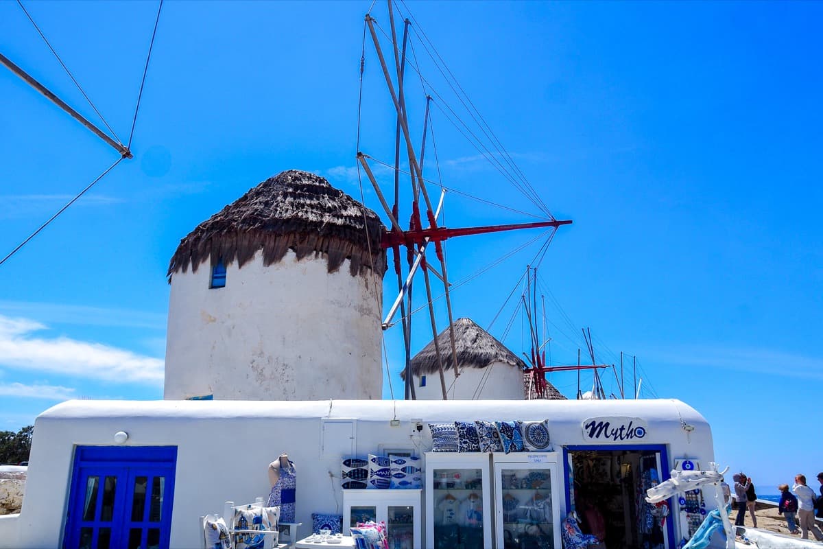 Iconic windmills of Mykonos overlooking the sparkling Aegean Sea with traditional Cycladic architecture