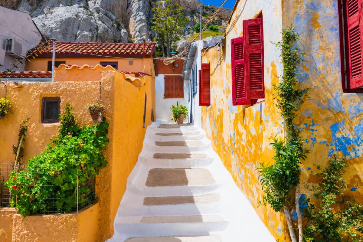 Colorful Greek architecture in Athens historic Plaka district with charming stairway and vibrant buildings.