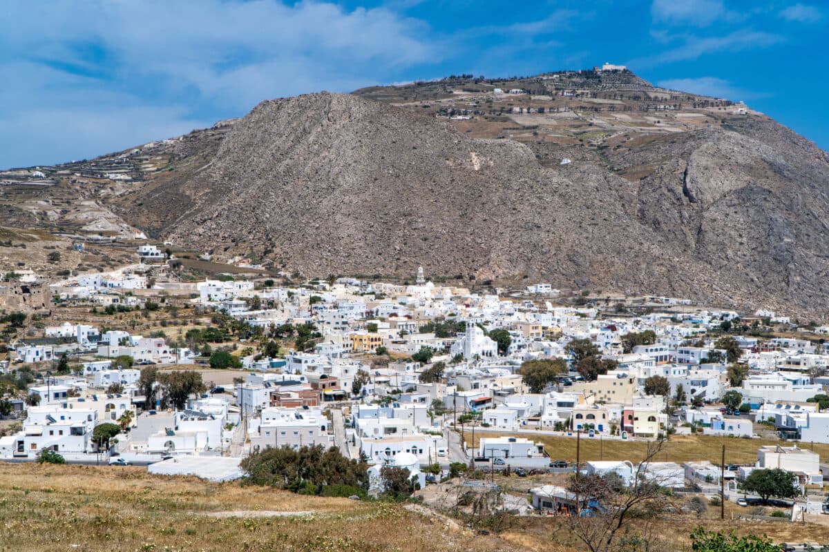 Panoramic view of Emporio Village in Santorini with whitewashed buildings and volcanic landscape.