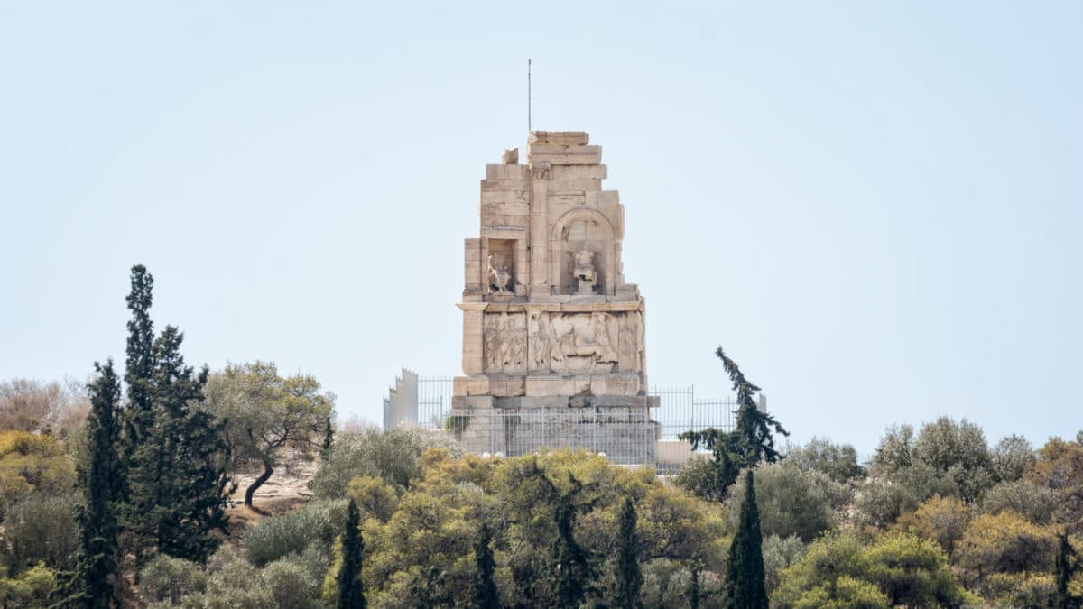 Philopappos Monument in Athens, Greece, an ancient Greek mausoleum on a hilltop surrounded by greenery.