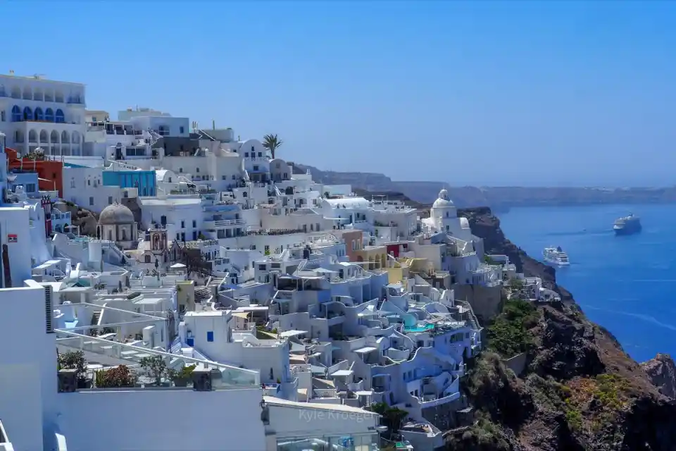 Santorini caldera with whitewashed houses and blue domes at sunset