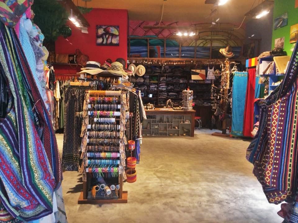 Vibrant artisanal The Secret Room shop with colorful textiles, handmade accessories, jewelry, hats, and traditional fashion.