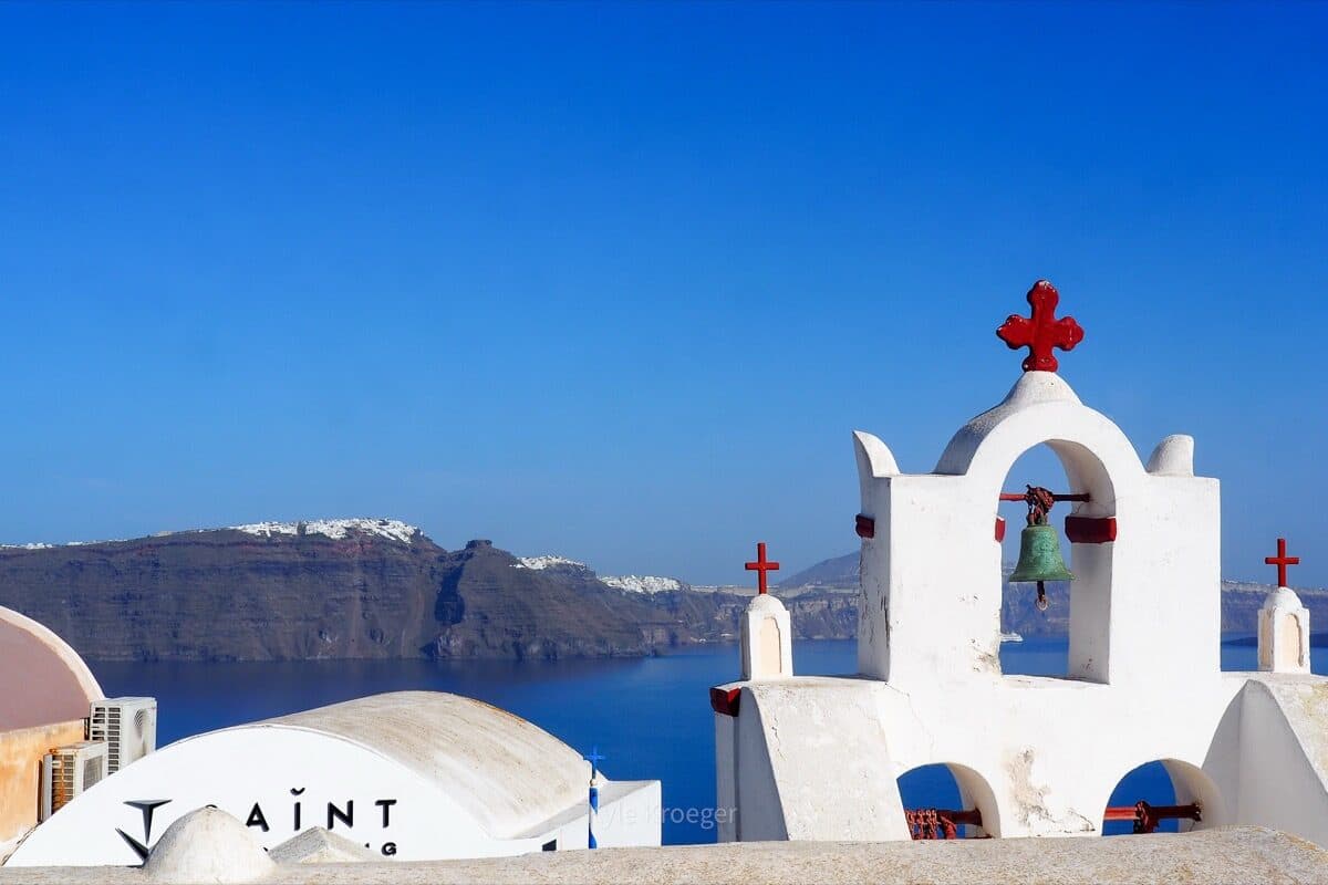 White church bell tower overlooking the Santorini caldera
