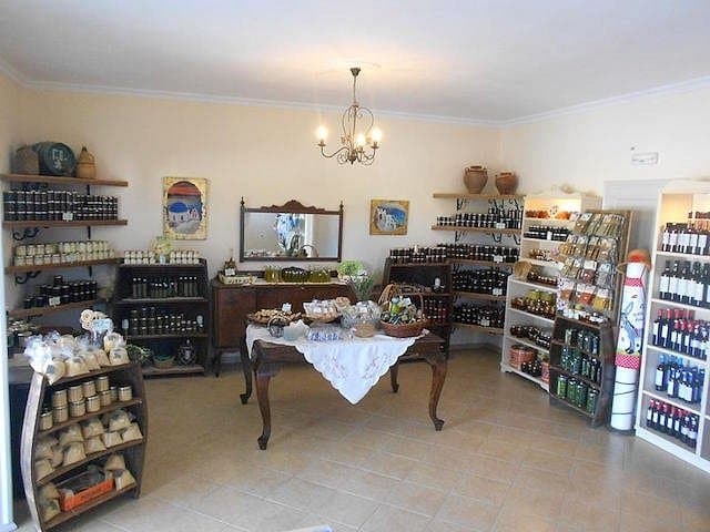 Faros Market artisanal food shop with wooden shelves, decorative decor, and charming display table.