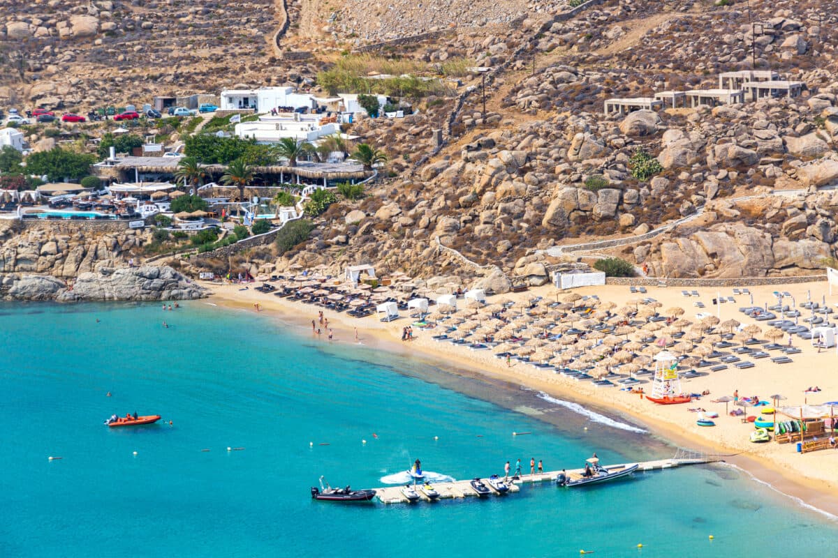 Beautiful Paradise Beach on Mykonos with turquoise waters, sun loungers, and vibrant beach atmosphere.