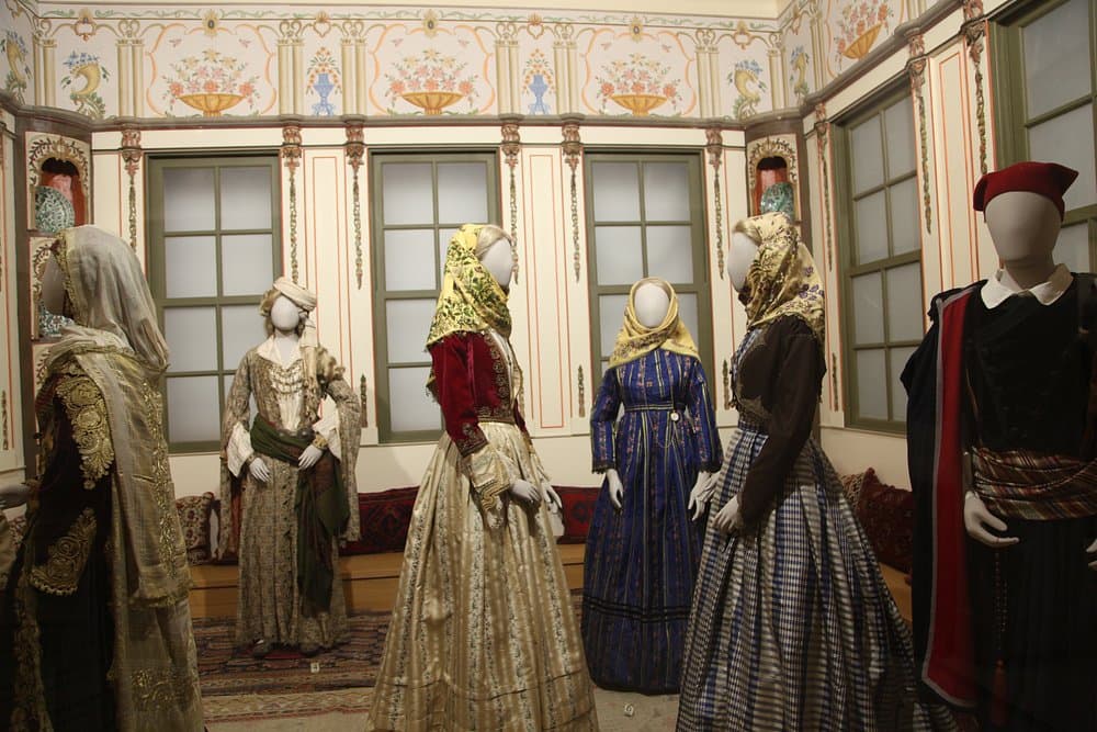 Benaki Museum Pireos, Greece cultural clothing display with mannequins in historical museum exhibit.