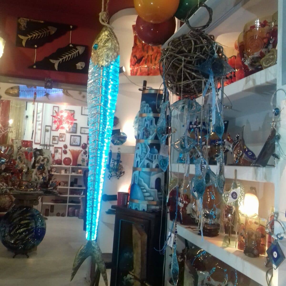 Santorini Art Glass glass and ceramic art shop featuring vibrant sculptures, wall hangings, and artistic decor.